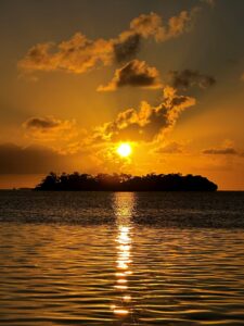 Islamorada sunset casting vibrant colors over calm waters, perfect for sunset tours and trips.
