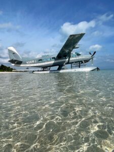 A seaplane gently floats on the crystal-clear waters of Islamorada, FL, showcasing the serene beauty of the Florida Keys